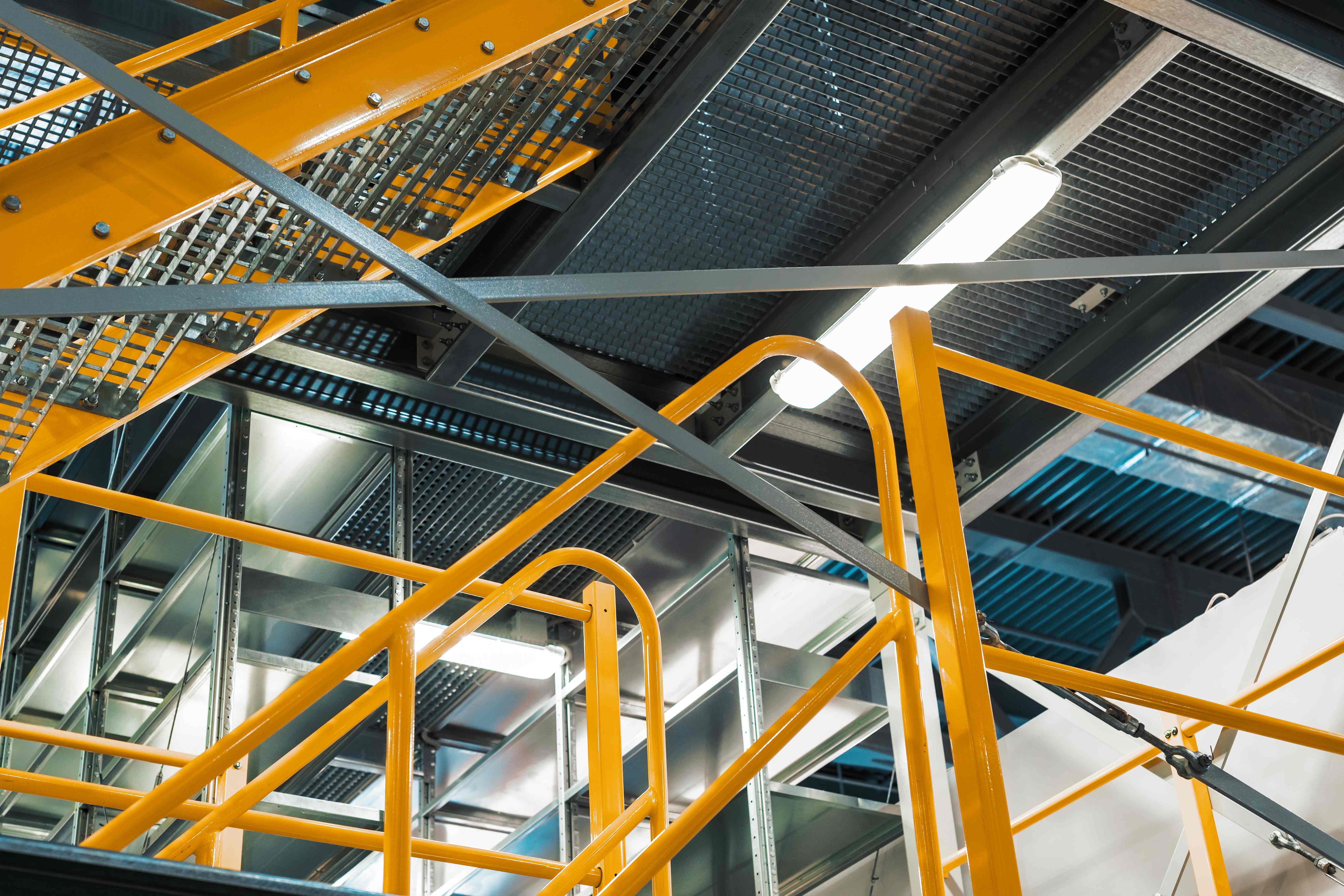 Yellow steel stairways inside an industrial plant